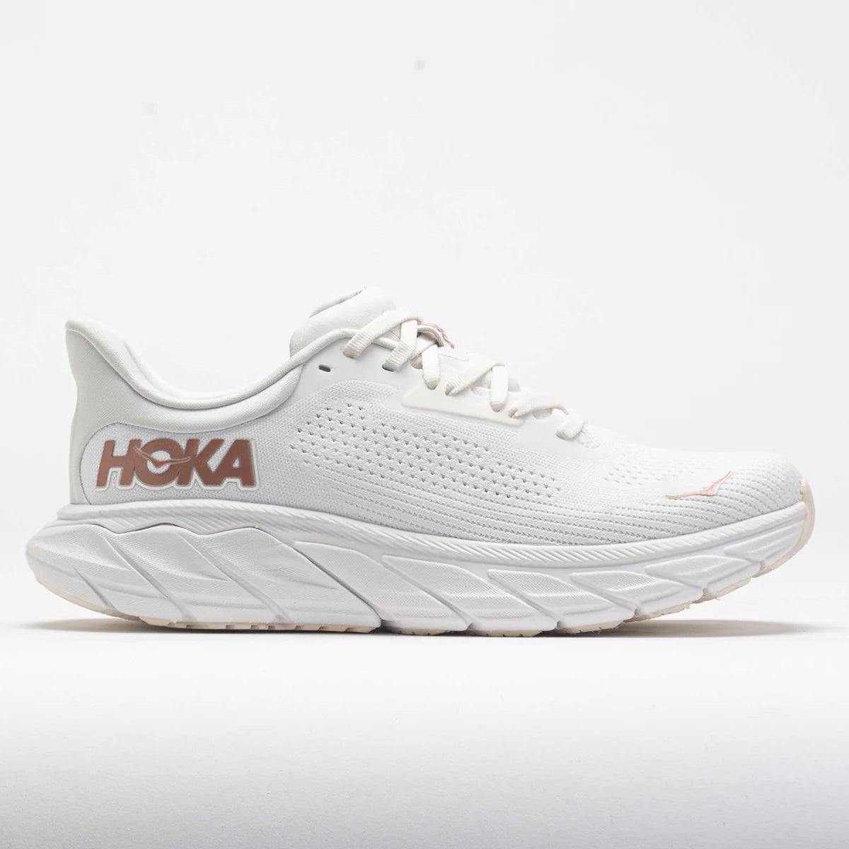 Side view of the HOKA Arahi 7 stability running shoe in white with a flat-knit upper, plush tongue, J-Frame™ midsole support, and extended heel pull, designed for everyday running and walking.