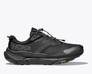 Side view of the HOKA Transport shoe in all-black with a quick-toggle lace, Vibram® EcoStep sole, Cordura® upper, and reflective details, designed for urban walking, hiking, and sustainable comfort.