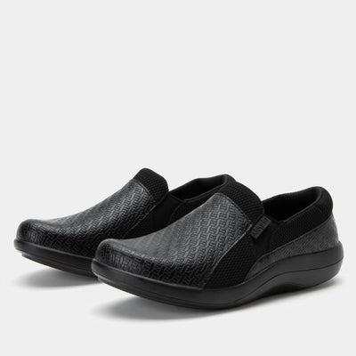 Alegria Women’s Duette slip-on in black woven vegan leather with elastic gores, padded collar, cushioned removable footbed, and slip-resistant sport rocker outsole.