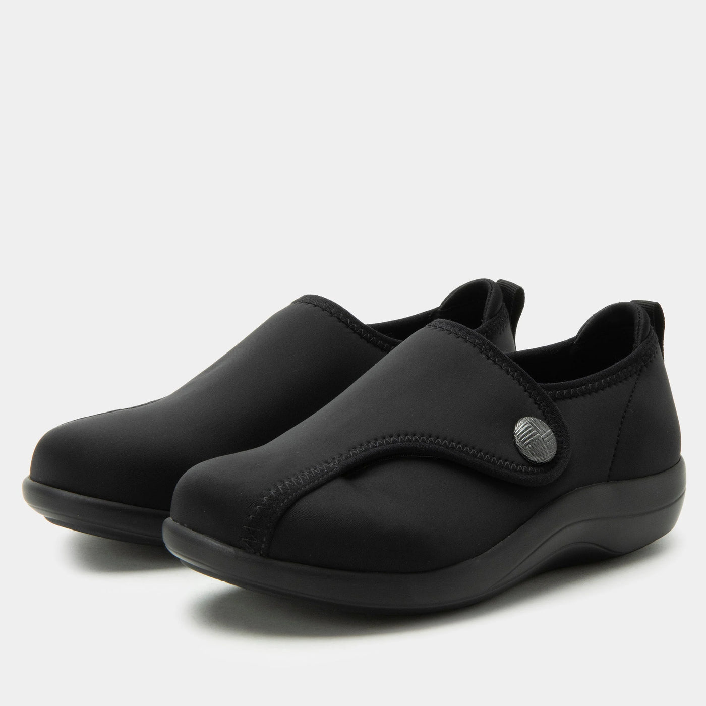 Black Alegria Marilynn stretch neoprene comfort shoes with adjustable strap, wide fit, cushioned lining, and slip-resistant outsole for flexible all-day wear.