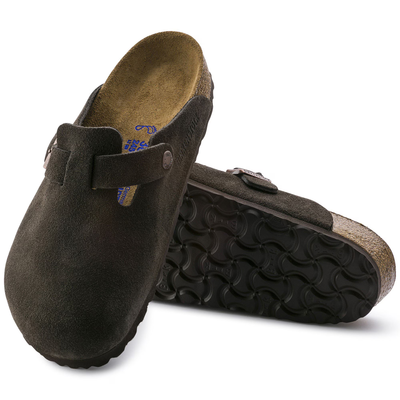 View of a Birkenstock Boston clog in mocha suede with an adjustable strap featuring a metal buckle, soft footbed, and cork-latex sole for comfort and support.