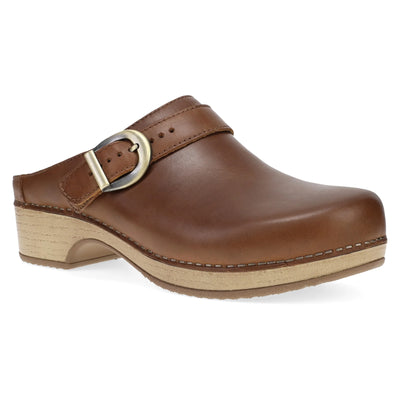 Classic tan oiled leather Dansko Baylor clog with buckle strap, cushioned dual-density EVA sole, and lightweight outsole.