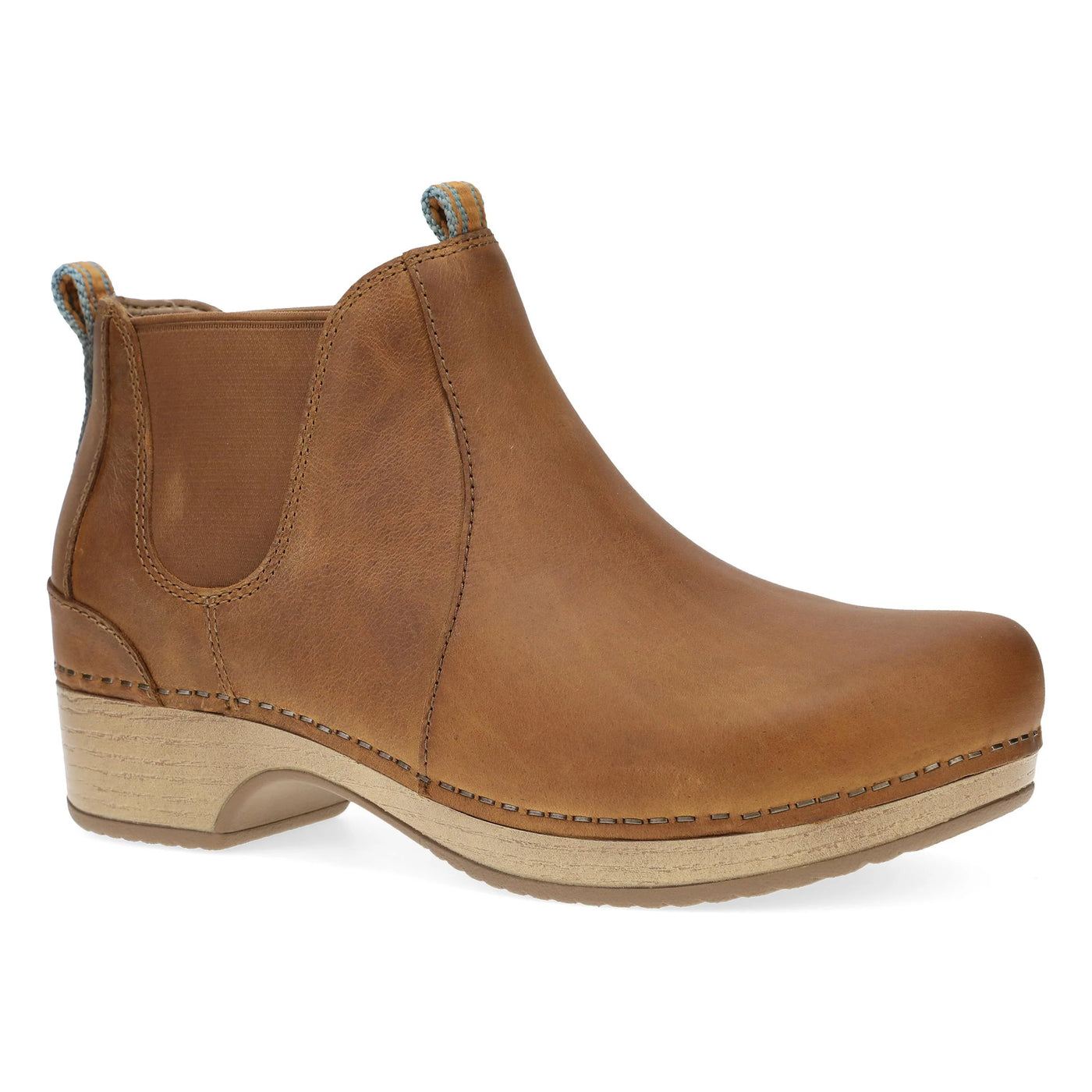 Dansko Women’s Becka ankle bootie in Tan Pull Up leather with side gore panels, pull tabs, and cushioned EVA footbed for all-day comfort and easy wear.