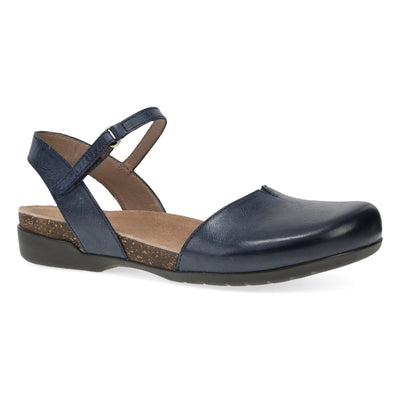 Dansko Women’s Rowan closed-toe sandal in navy leather with ankle strap, cushioned memory foam footbed, and cork midsole for all-day comfort.