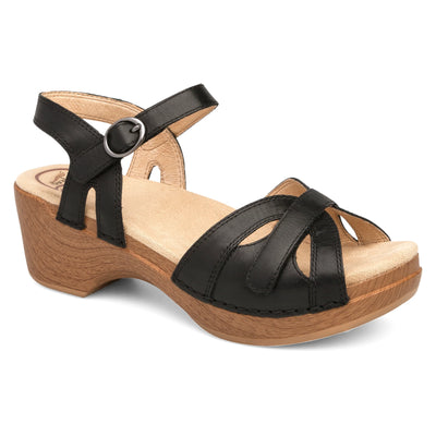 Black leather sandal with open toe, ankle strap, and wood-look platform heel, featuring hook-and-loop closures and cushioned insole for comfort.