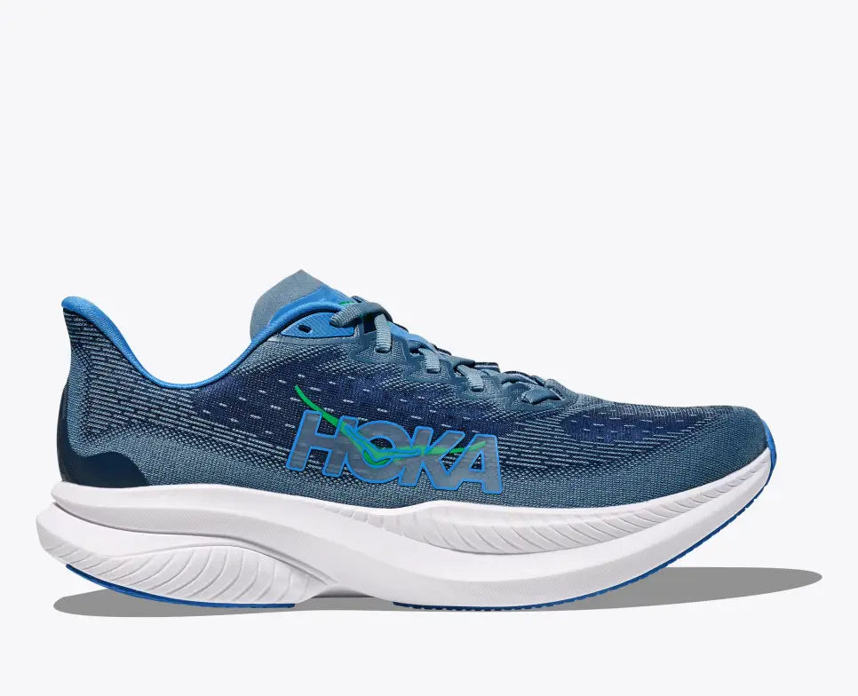 Side view of a blue HOKA Mach 6 running shoe with breathable mesh uppers, a bright blue and green HOKA logo on the side, and a thick white cushioned sole with blue detailing for enhanced performance and comfort.