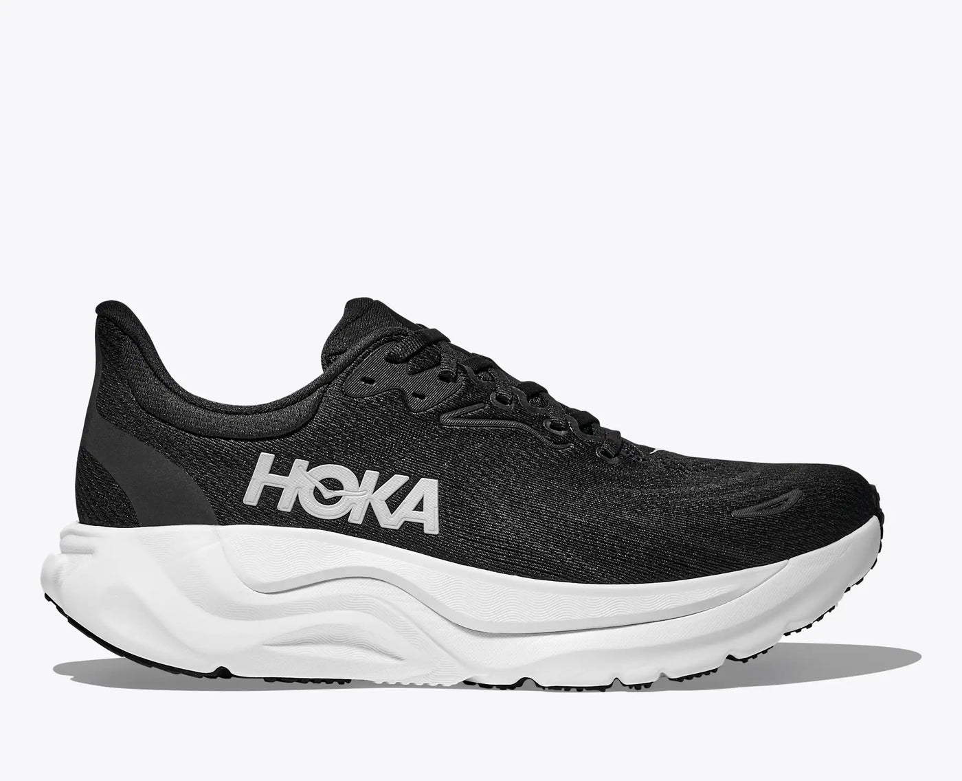 Women’s HOKA Arahi 8 in Black/White featuring stabilizing H-Frame™ technology, breathable jacquard mesh, and dual-density EVA cushioning for comfort and control.