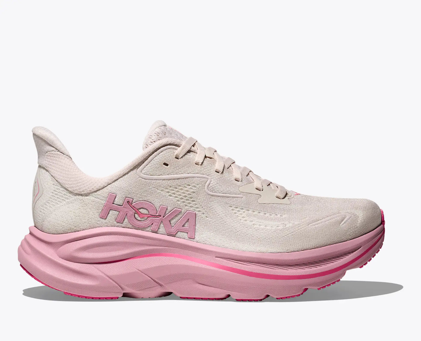 HOKA Clifton 10 women’s trainer in cream and pink, offering lightweight cushioning, 3mm added drop, and a smooth MetaRocker™ for everyday running and walking.