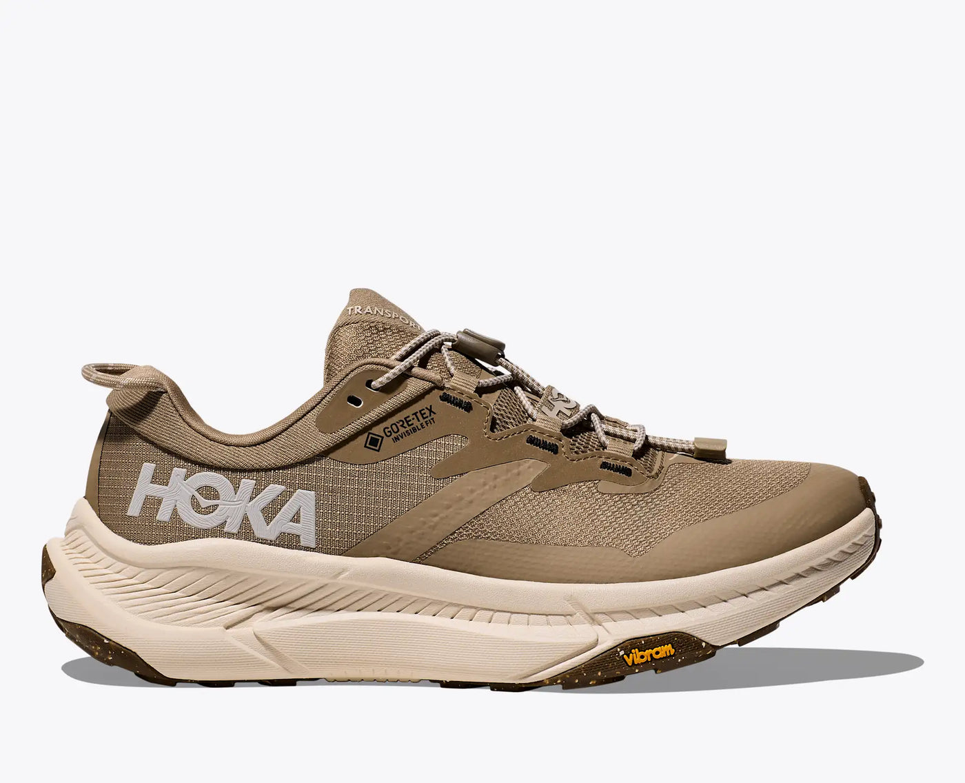 Women’s HOKA Transport GTX commuter shoe in  EGGNOG color, designed with sustainable materials, waterproof GORE-TEX, and Vibram® recycled rubber outsole for durability.