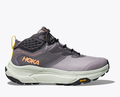 Women’s HOKA Transport Hike GTX waterproof hiking shoe in Grey Skies/Sea Grass with GORE-TEX protection, Vibram® outsole, and recycled mesh upper.