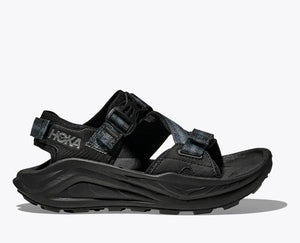 HOKA Infini Hike TC adventure women sandal in black, featuring adjustable straps, Ariaprene® upper, a dual-density sugarcane midsole, and a Vibram® Megagrip outsole for all-terrain stability and comfort.