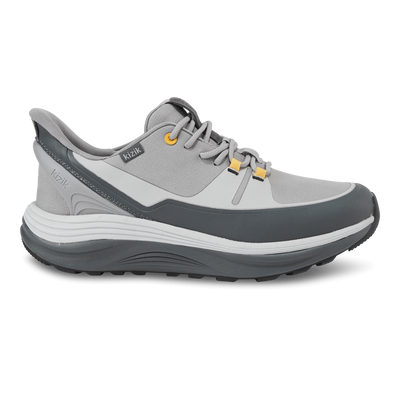 Kizik London AT men’s sneaker in alloy gray with poppy orange accents, rugged sole, lace-up front, and spring-back heel for hands-free wear and all-terrain travel comfort.