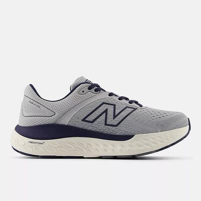 New Balance men’s grey and navy sneaker with Fresh Foam X midsole, ROLLBAR stability system, and breathable engineered knit upper for everyday comfort and support.