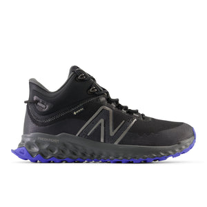 Black and gray New Balance Fresh Foam Garoé MID trail shoe with GORE-TEX lining, bold N logo, and purple AT Tread outsole for comfort, grip, and durability on all terrains.