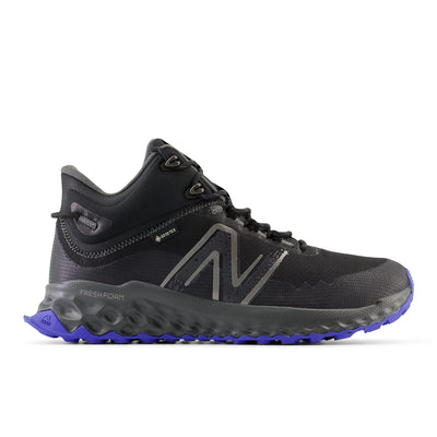 Black and gray New Balance Fresh Foam Garoé MID trail shoe with GORE-TEX lining, bold N logo, and purple AT Tread outsole for comfort, grip, and durability on all terrains.