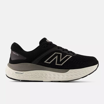 New Balance black and gray running shoe with Fresh Foam X midsole and ROLLBAR stability system, featuring engineered knit upper and cushioned sole for all-day comfort and support.