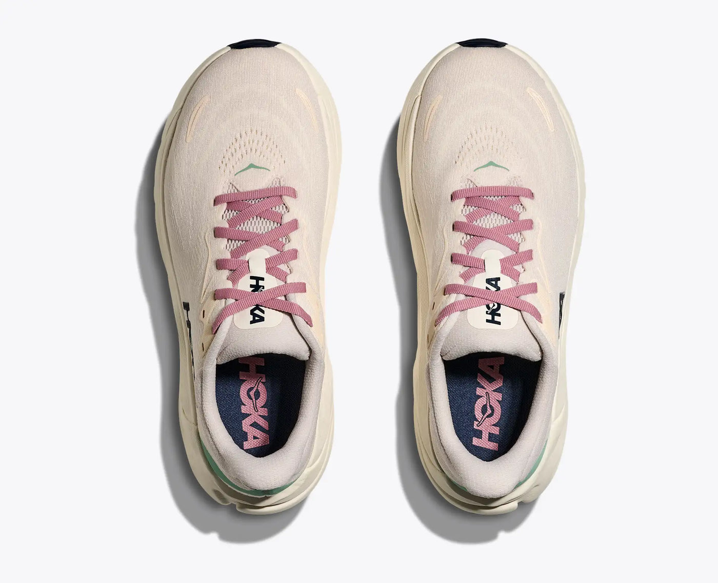 Top view of HOKA Women’s Arahi 8 stability running shoes in rose cream and alabaster, featuring pink laces, jacquard mesh upper, and cushioned EVA midsole for everyday runs.