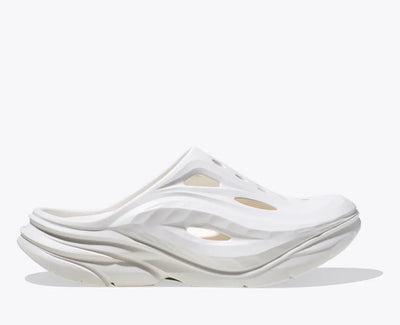 HOKA Ora Recovery Mule in white color, featuring a sculpted EVA design with vented airflow channels, a sugarcane EVA midsole, and a futuristic slip-on silhouette for enhanced breathability and comfort.
