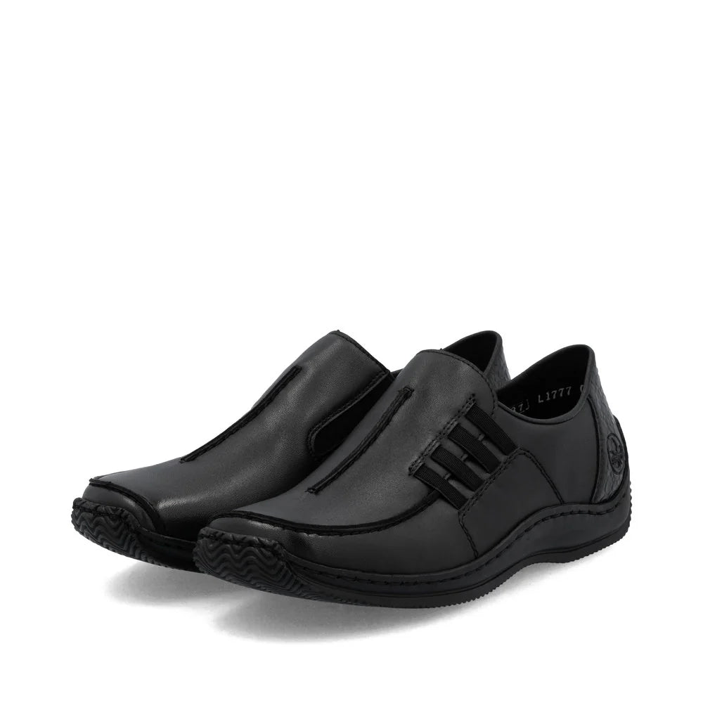 Rieker Women’s Black leather slip-on shoes with elastic side panels, flexible sole, and minimalist design for lightweight all-day comfort.