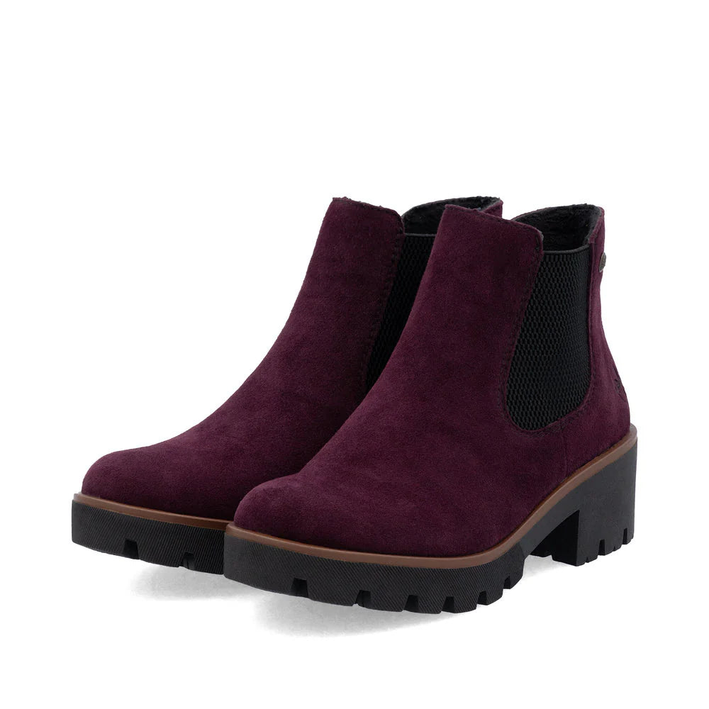 Rieker Women’s Burgundy suede Chelsea boots with chunky lug sole, slip-on elastic panels, and block heel for stylish all-day comfort.