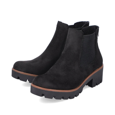Women’s Rieker Black suede ankle boots featuring elastic sides, chunky tread sole, and 2-inch heel for lift and stability.