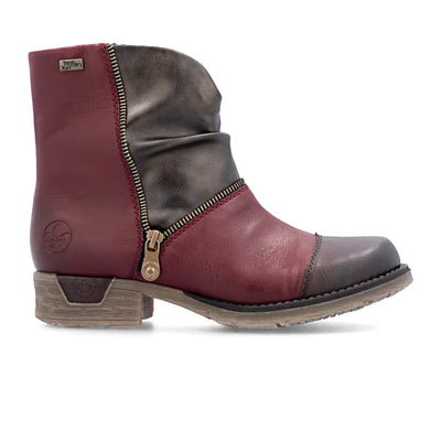 Rieker Women’s Wine Multi ankle boots with color-blocked synthetic leather, decorative side zipper, and grippy sole for flexible, water-repellent comfort.