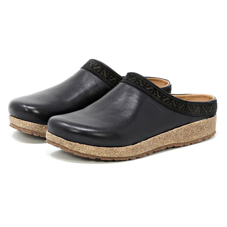 Women’s Stegmann Graz clog in black vegetable-tanned leather with cork-latex midsole, removable felt-lined insole, roomy toe box, and textured rubber outsole; pair shown at angle.
