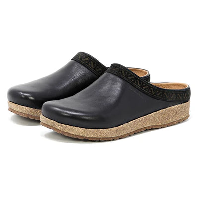 Women’s Stegmann Graz clog in black vegetable-tanned leather with cork-latex midsole, removable felt-lined insole, roomy toe box, and textured rubber outsole; pair shown at angle.
