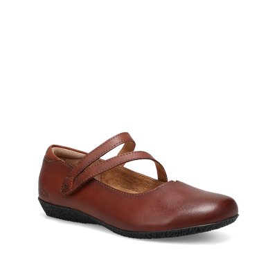 Women’s Taos Banter cognac flats with luxe leather upper, secure V-strap style, cushioned microfiber lining, and orthotic-friendly removable footbed.