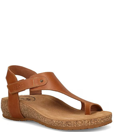 Women’s Taos Fame sandals in TAN leather with toe loop design, adjustable ankle strap, cushioned arch support, cork midsole, and flexible rubber outsole.