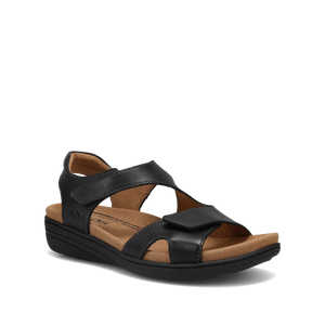 Black leather sandal with hook-and-loop straps, cushioned microfiber footbed, arch and metatarsal support, and a low wedge heel on a flexible black rubber outsole.