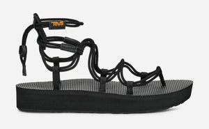 Black platform gladiator sandal with recycled strappy upper, quick-release bungee lacing, cushioned EVA midsole, and durable rubber sole for all-day comfort and everyday wear.