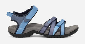 Blue and gray Teva Tirra sandal with multiple adjustable straps, cushioned heel pad, contoured EVA midsole, and durable Spider Rubber outsole for comfort on light and day hikes.