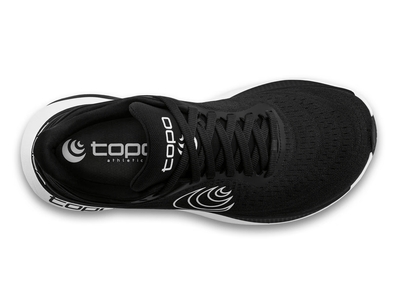 Top view of a black Topo running shoe with a white swirl logo on the side, 'topo' branding on the white cushioned sole, and a sleek, lightweight design for performance and comfort.