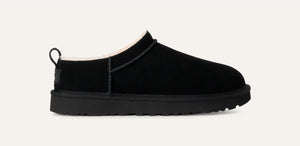 Black low-profile suede boot with plush sheepskin lining, rear pull tab, and lightweight sugarcane EVA sole; side view of UGG Classic Micro.