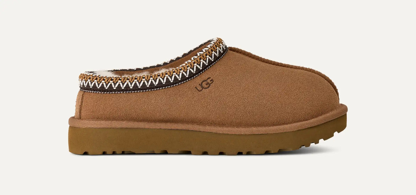 Chestnut suede Tasman II mule by UGG, low-profile slip-on with colorful braided collar and cushioned sugarcane EVA sole; indoor/outdoor.