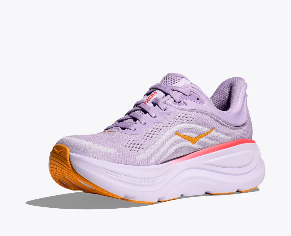 Side view of a lavender HOKA running shoe with breathable mesh uppers, yellow HOKA logo, and orange accents on the sole and heel, featuring a cushioned midsole for added support.