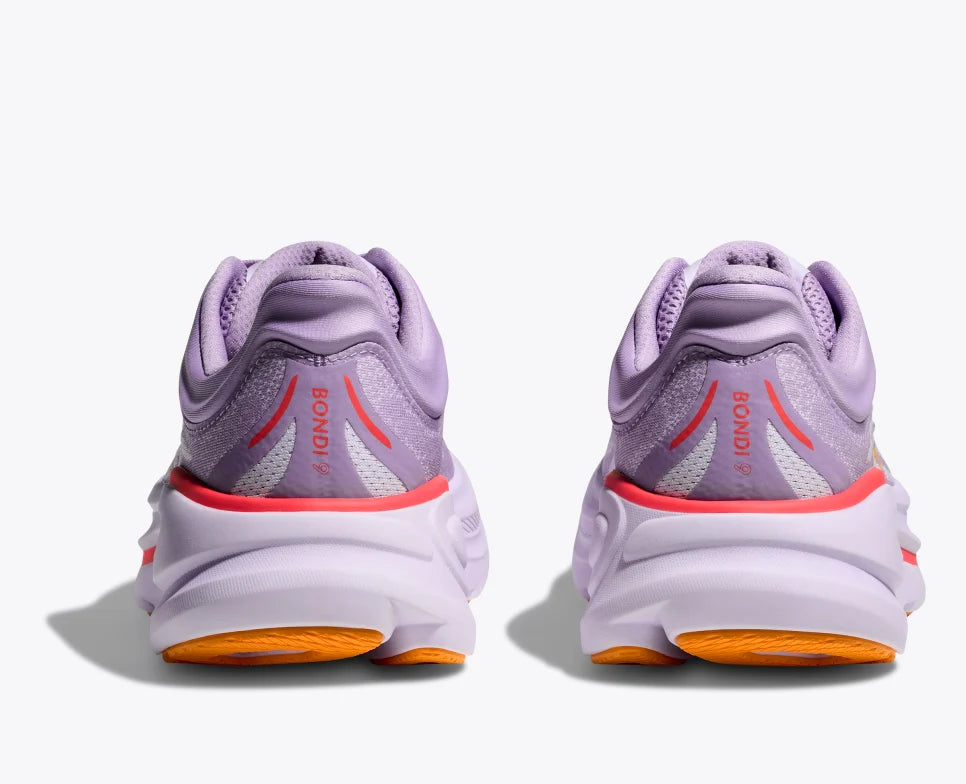 Back view of a lavender HOKA running pair of shoes with breathable mesh uppers, yellow HOKA logo, and orange accents on the sole and heel, featuring a cushioned midsole for added support.