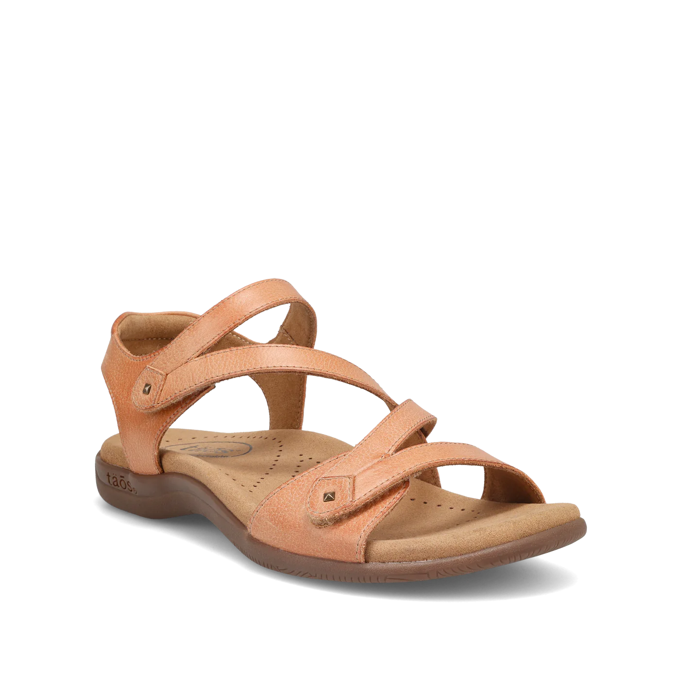 Angled view of a natural beige Taos sandal featuring adjustable straps, a cushioned footbed with perforations, and a supportive sole.