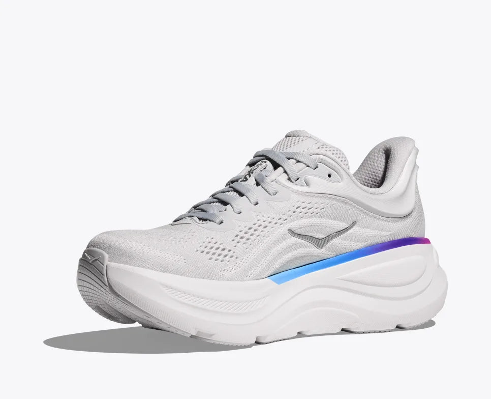 Side view of white HOKA running shoes with breathable mesh uppers, purple and blue gradient detailing on the heels, and the HOKA logo visible on the insoles.