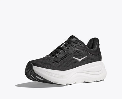 Side view of a black HOKA running shoe with breathable mesh uppers, white HOKA logo, and a thick white cushioned sole designed for comfort and support.