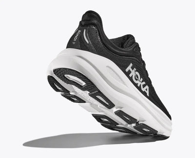 Angle view of a black HOKA running shoe with breathable mesh uppers, white HOKA logo, and a thick white cushioned sole designed for comfort and support.