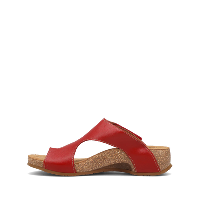 Side view of a pair of red Taos sandals featuring a slip-on design with a soft suede footbed and subtle stitching details.