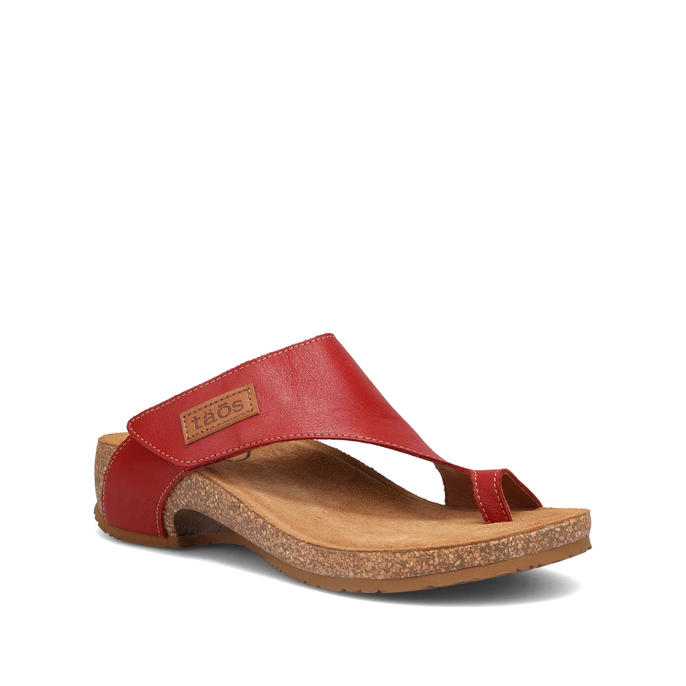 Side view of a pair of red Taos sandals featuring a slip-on design with a soft suede footbed and subtle stitching details.