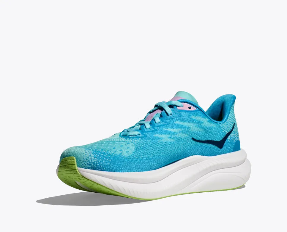 Side view of a turquoise HOKA running shoe with breathable mesh uppers, reflective HOKA logo, pink accents on the tongue, and a thick white cushioned sole with lime green detailing on the outsole.