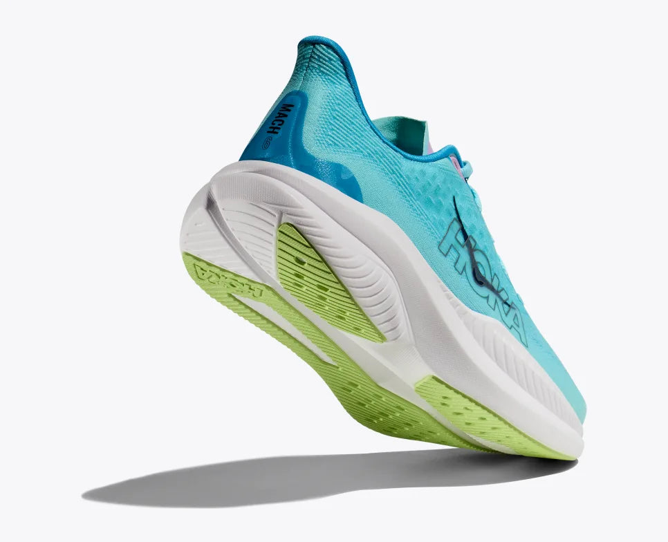 Angle view of a turquoise HOKA running shoe with breathable mesh uppers, reflective HOKA logo, pink accents on the tongue, and a thick white cushioned sole with lime green detailing on the outsole.